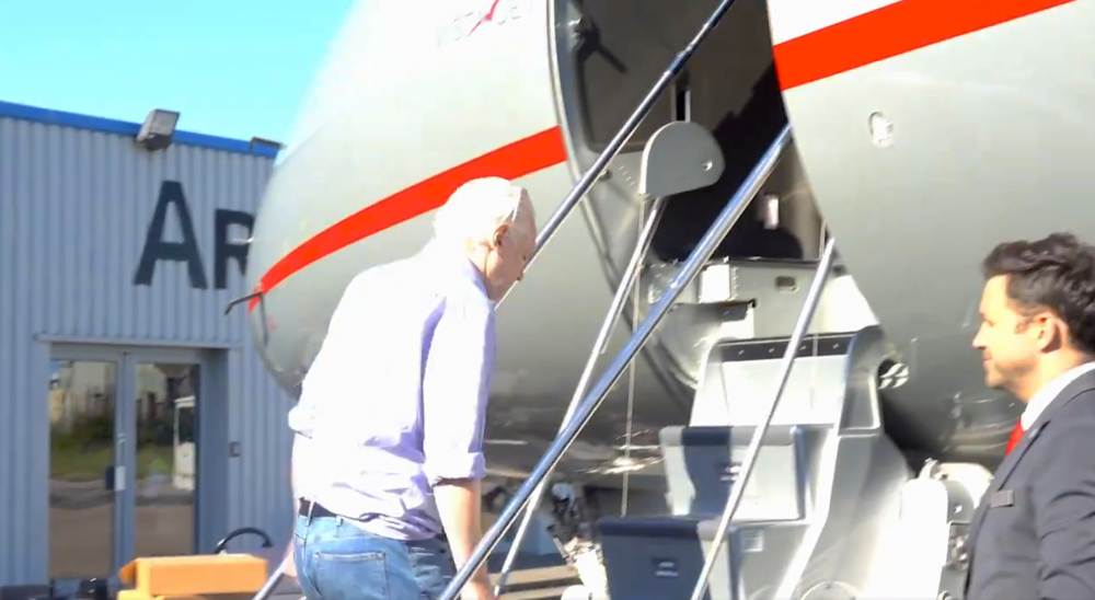 Julian Assange boards plane at Stansted Airport in London